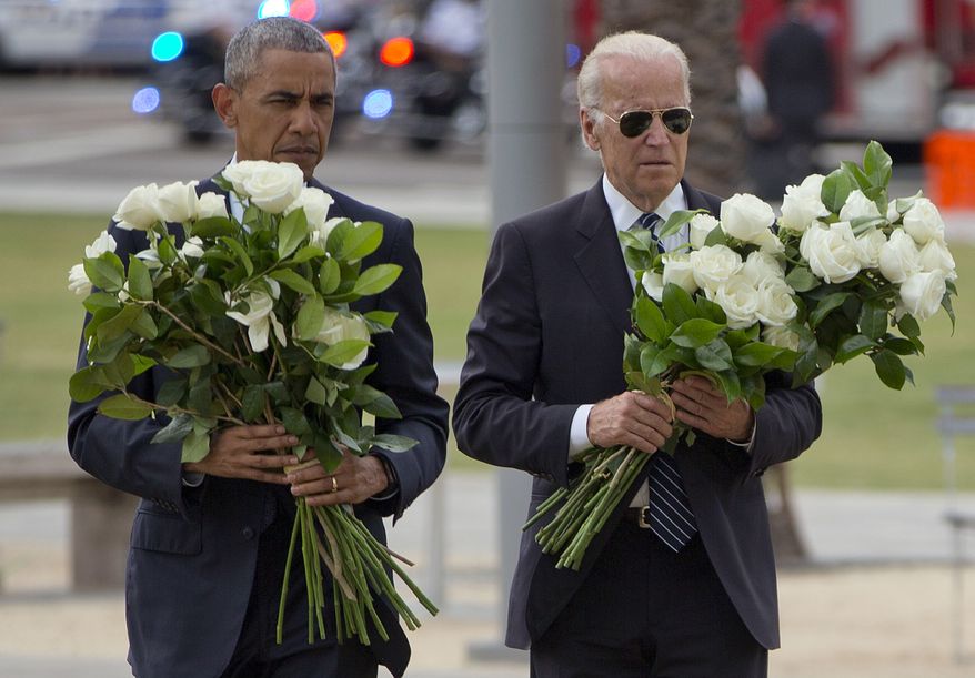 President Barack Obama with Vice President Joe Biden carry bouquets comprised of a total of 49 white roses, one in honor of each of the deceased victims, as they visit a memorial to the victims of the Pulse nightclub shooting, Thursday, June 16, 2016 in Orlando, Fla. Offering sympathy but no easy answers, Obama came to Orlando to try to console those mourning the deadliest shooting in modern U.S history. (AP Photo/Pablo Martinez Monsivais)