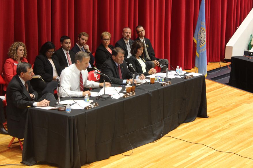 From left, Republican U.S. Sens. John Barrasso, of Wyoming, John Thune and Mike Rounds, both of South Dakota, and Republican U.S. Rep. Kristi Noem, also of South Dakota, participate in a field hearing of the U.S. Senate Committee on Indian Affairs on Friday, June 17, 2016, in Rapid City, South Dakota. The hearing centered on proposed legislation aimed at fixing shortcomings at the network of hospitals run by the Indian Health Service. (AP Photo/Regina Garcia Cano)