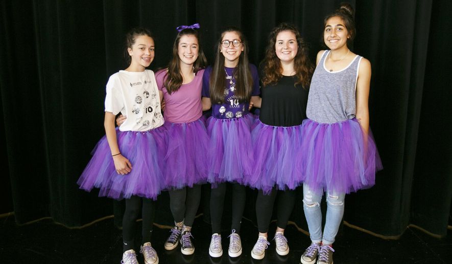 Straub Middle School students Cammie Alves, Megan Vaughn, Olivia Nell, Savannah Jones and Amani Noor pose for a photo in their purple tutus on Friday, June 3, 2016. Eighth grader Olivia Nell has epilepsy and is organizing a walk to raise awareness for the seizure disorder; her mother Lisa Nell made the tutus to celebrate epilepsy awareness. (Molly J. Smith/Statesman Journal via AP)