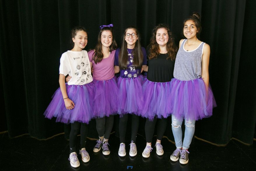 Straub Middle School students Cammie Alves, Megan Vaughn, Olivia Nell, Savannah Jones and Amani Noor pose for a photo in their purple tutus on Friday, June 3, 2016. Eighth grader Olivia Nell has epilepsy and is organizing a walk to raise awareness for the seizure disorder; her mother Lisa Nell made the tutus to celebrate epilepsy awareness. (Molly J. Smith/Statesman Journal via AP)