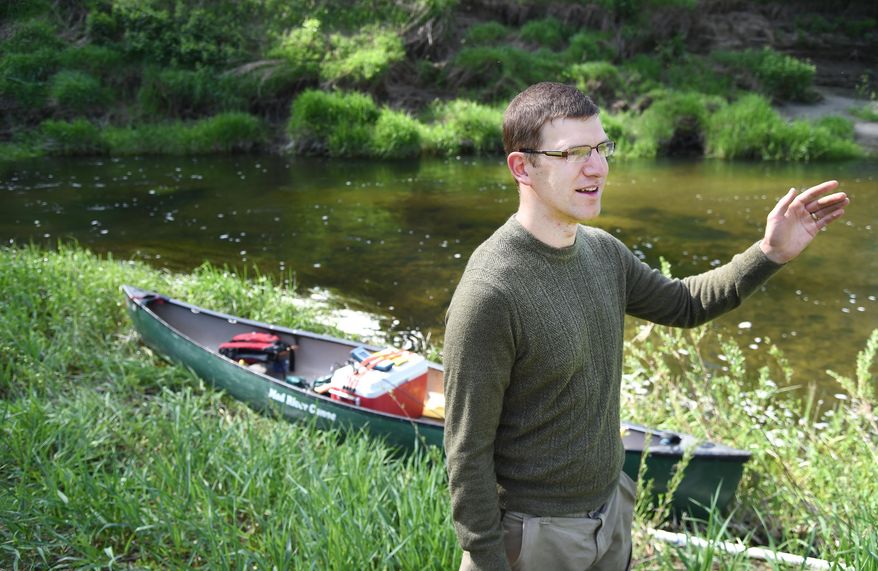 In this April 28, 2016 photo, Department of Ecology water quality modeler Tighe Stuart, who has spent several days paddling a canoe, towing a testing probe, down Hangman Creek, as he prepares to cover the last few miles of water quality testing on the creek, speaks in Spokane, Wash. Stuart and another tester are recording comprehensive water quality measurements and and stream depth measurements which will be used in models that officials will use to create a water quality plan for the creek, a major tributary of the Spokane River. (Jesse Tinsley/The Spokesman-Review via AP) COEUR D'ALENE PRESS OUT; MANDATORY CREDIT