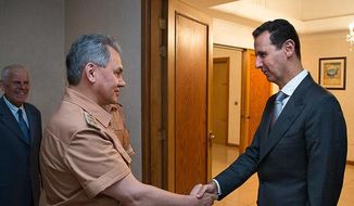 Syrian President Bashar Assad shakes hands with Russian Defense Minister Sergei Shoigu in Damascus, Syria, Saturday, June 18, 2016. Russia&#39;s defense minister visited Syria on Saturday to meet the country&#39;s leader and inspect the Russian air base there, a high-profile trip intended to underline Moscow&#39;s role in the region. (Vadim Savitsky/ Russian Defense Ministry Press Service pool photo via AP)