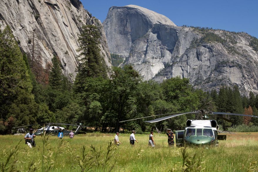 The Obamas toured Yosemite, the country's oldest national park, to mark the 100th anniversary of the park system. President Obama, who said rising temperatures are damaging national parks, has proposed a 9 percent increase to boost the National Park Service's annual funding to $3.1 billion. (Associated Press)