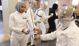 FILE - In this June 2, 2016, file photo, Team Visa athlete Ibtihaj Muhammad leads an interactive fencing demonstration in New York. This year more than ever, the so-called ``face&#39;&#39; of the Olympics could be a wrestler, or a fencer, or an athlete who most of the world has never heard of before. Visa, an Olympic sponsor for the past three decades, has a long list of the well-known _ Walsh-Jennings, Franklin, Carli Lloyd _ along with those who are not yet household names. Namely, Muhammad, the Muslim fencer who chose her sport in part because it allowed her to compete while wearing a hijab. (AP Photo/Charles Sykes, File)