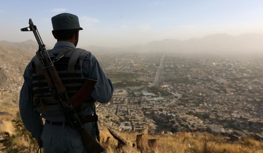 An Afghan policeman watches over Kabul. (Associated Press/File)