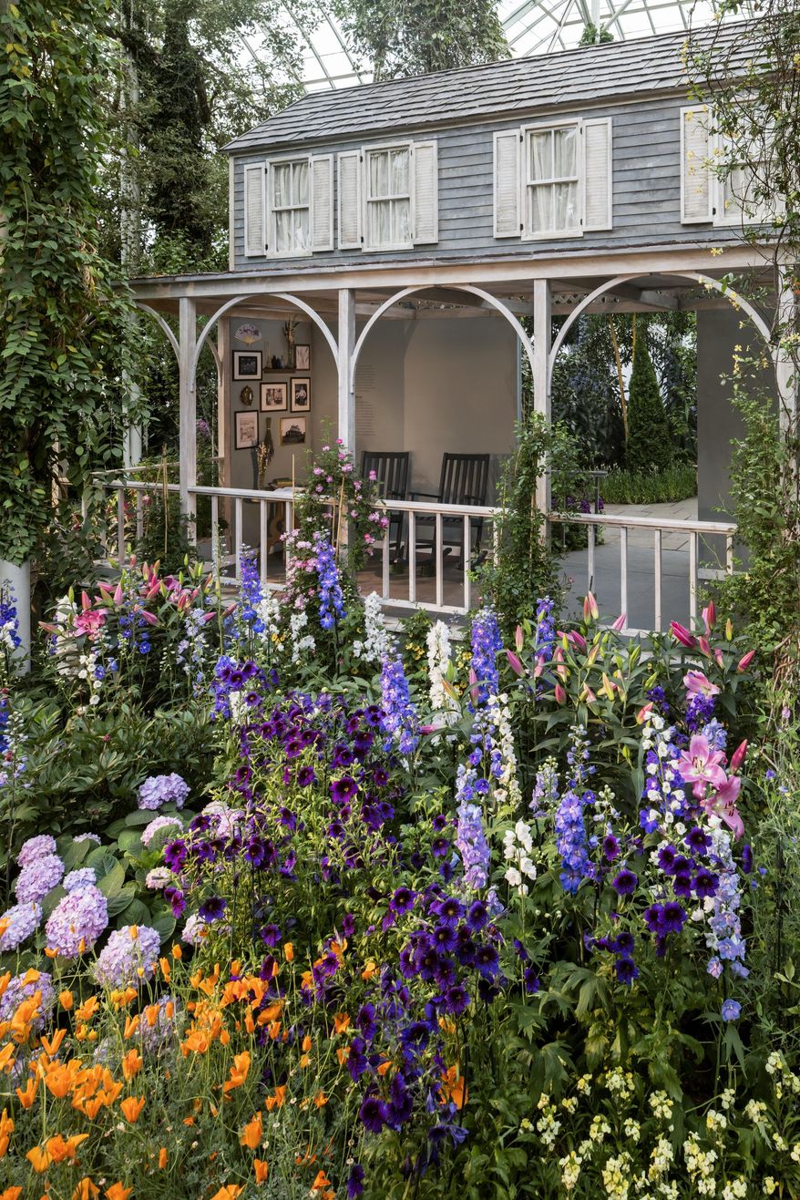 This undated photo provided by the New York Botanical Garden shows a Colonial-era style garden, "grandmother's garden," planted around the facade of a house inside the Botanical Garden's Enid A. Haupt Conservatory in New York. The garden was the type favored by American Impressionist painters. It is part of an exhibit at the Botanical Garden titled "Impressionism: American Gardens on Canvas," and runs through Sept. 11, 2016. (Robert Benson/New York Botanical Garden via AP)