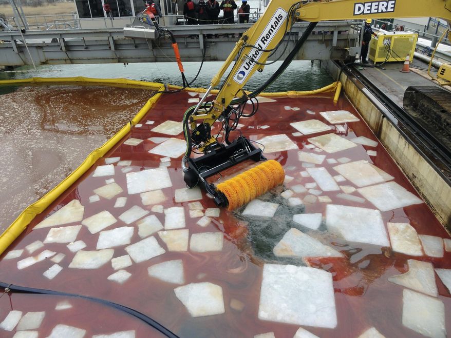 This undated photo provided by Enbridge Energy shows a bucket skimmer, which is used to remove spilled oil from icy patches in waterways. Enbridge says it will keep two similar devices in storage near the Straits of Mackinac, the waterway where Lakes Huron and Michigan meet. Twin pipelines owned by Enbridge carry millions of gallons of oil daily beneath the straits, and Enbridge says the equipment will be available in the event of a spill. (Enbridge Energy via AP)