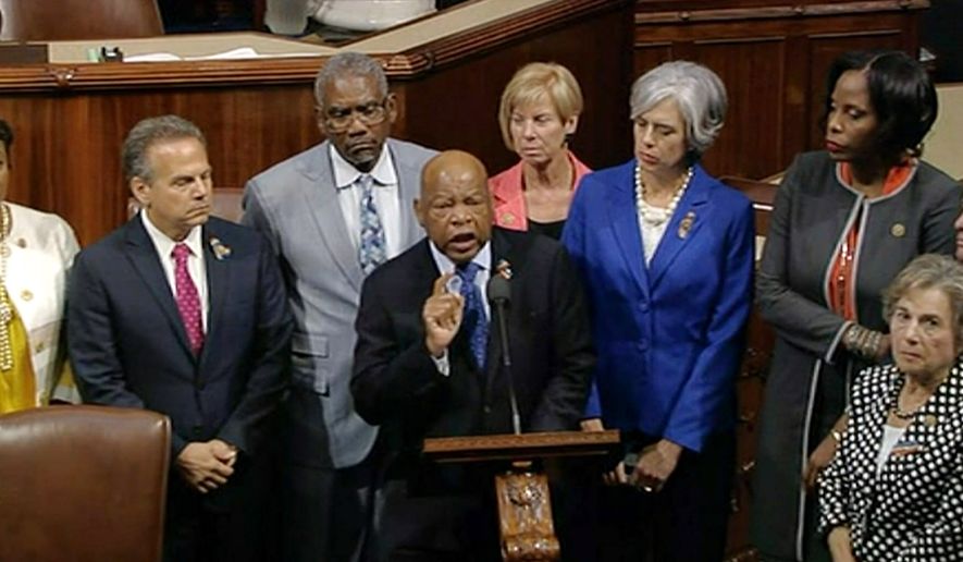 In this frame grab taken from AP video Georgia Rep. John Lewis leads more than 200 Democrats in demanding a vote on measures to expand background checks and block gun purchases by some suspected terrorists in the aftermath of last week's massacre in Orlando, Florida, that killed 49 people in a gay nightclub. (AP Photo)