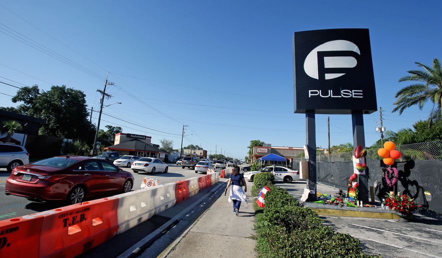 Traffic moves along Orange Avenue after authorities opened the streets around the Pulse nightclub, scene of the recent mass shooting, Wednesday, June 22, 2016, in Orlando, Fla. (AP Photo/John Raoux)
