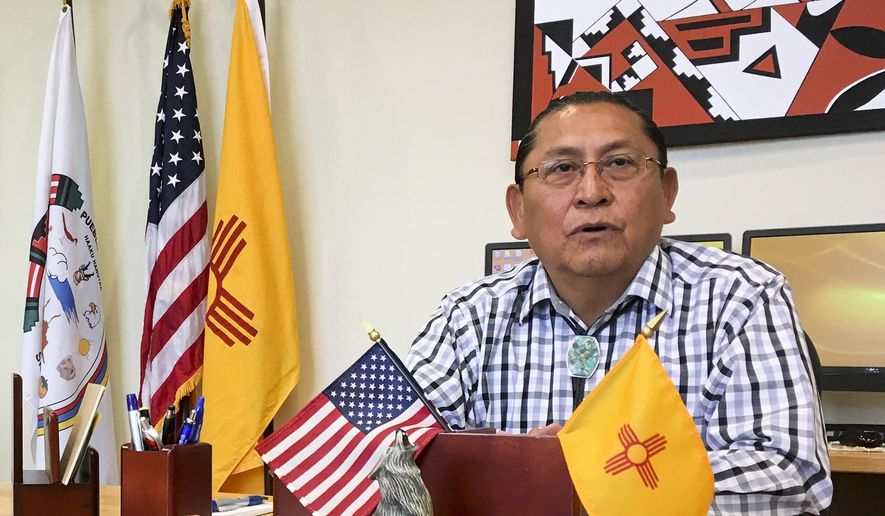 In this June 8, 2016, photo, Gov. Kurt Riley, of Acoma Pueblo, discusses his tribe's move to repatriate a ceremonial shield from Paris, France during an interview in Acoma Pueblo, New Mexico. Amid protest from the Pueblo, the shield was pulled from the auction block in a rare, last-minute move that has been hailed by tribes and questioned by some collectors. (AP Photo/Mary Hudetz)