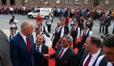 Albanian Prime Minister Edi Rama, left, welcomes the Albanian national soccer squad arriving in Tirana after failing to qualify to the next round at the EURO 2016 European Championship, Thursday, June 23, 2016.(AP Photo/Hektor Pustina)