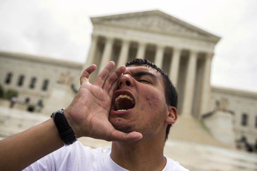 Gerson Quinteron of Washington participates in a demonstration on immigration Thursday at the Supreme Court. A tie vote by the justices effectively kills President Obama's plan to shield millions from deportation for the remainder of his term. (Associated Press)