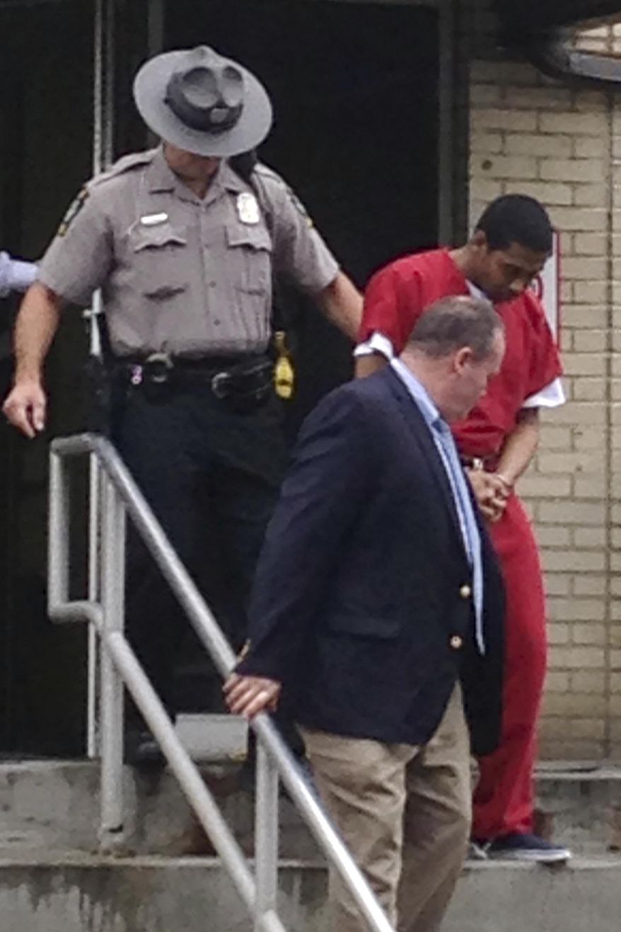 Robert Thomas is escorted from the Allegheny County Police headquarters in Pittsburgh, Thursday, June 23, 2016. Authorities have charged Thomas and Cheron Shelton with multiple counts of criminal homicide for a March ambush at a backyard cookout in Wilkinsburg. (AP Photo)