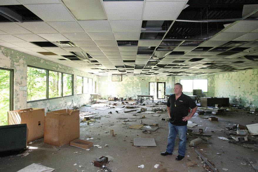 ADVANCE FOR USE SUNDAY, JUNE 26 AND THEREAFTER - In this June 8, 2016 photo, Vieweg Real Estate managing broker Tim Vieweg shows what used to be the break room at the former Wagner Castings Plant. in Decatur, Ill. Though the property is in disrepair, Vieweg considers the rail access a substantial asset and is working to improve the plot of land in hopes of finding a new employer for it. (Jim Bowling/Herald & Review via AP) MANDATORY CREDIT