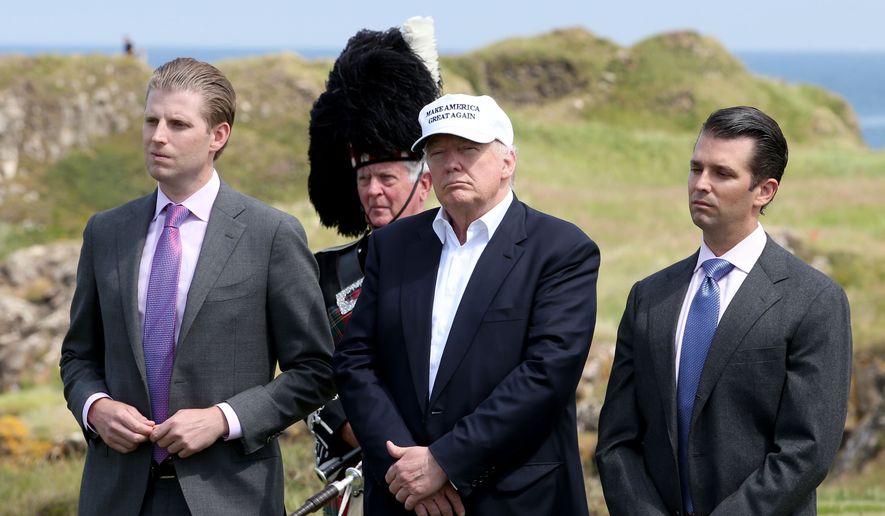 Donald Trump, center, with his sons Eric, left, and Donald Trump Jr. during a ceremony at his revamped Trump Turnberry golf course in Turnberry Scotland on Friday, June 24, 2016. (Jane Barlow/PA via AP) ** FILE **