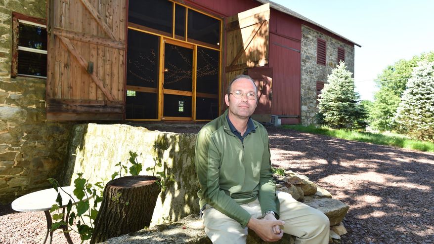 ADVANCE FOR SATURDAY, JUNE 25, 2016, AND THEREAFTER - Meadowbrook Farm owner Paul Sarver sits in front of a refurbished barn where he's hosted weddings and other events at the bed-and-breakfast property he and his wife run, on June 10, 2016, in Zionsville, Pa. In picturesque areas with an agriculture heritage, regulatory hurdles and complaints from neighbors sometimes frustrate efforts by entrepreneurial property owners to host barn weddings and other agritourism activities. (April Bartholomew/The Morning Call via AP) THE EXPRESS-TIMES OUT; WFMZ OUT; MANDATORY CREDIT