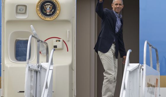 President Barack Obama waves as he boards Air Force One prior to his departure from Seattle-Tacoma International Airport in SeaTac, Wash., Saturday, June 25, 2016.  (AP Photo/John Froschauer)