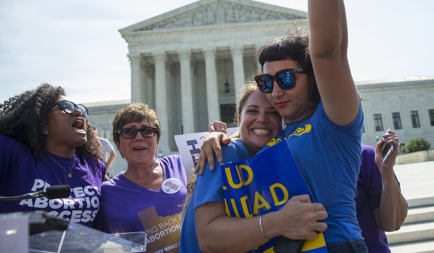 Bethany Van Kampen, left, hugs Alejandra Pablus as they celebrate during a rally at the Supreme Court in Washington, Monday, June 27, 2016, after the court struck down Texas&#x27; widely replicated regulation of abortion clinics. The justices voted 5-3 in favor of Texas clinics that had argued the regulations were a thinly veiled attempt to make it harder for women to get an abortion in the nation&#x27;s second-most populous state. (AP Photo/Evan Vucci)