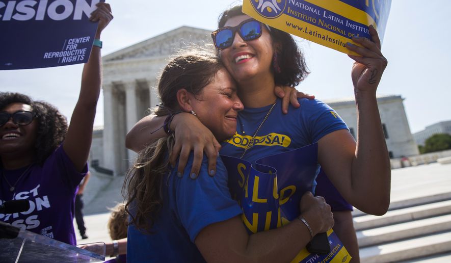Bethany Van Kampen (left) hugs Alejandra Pablus as they celebrate during a rally at the Supreme Court in Washington on Monday after justices struck down Texas' widely replicated regulation of abortion clinics. (Associated Press)