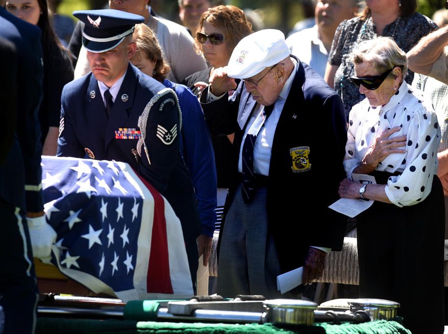 Dawn Thatcher, right, widow of David Thatcher, and Lt. Col. Dick Cole, now the last living Doolittle Raider, react with a hand on the heart and a salute Monday, June 27, 2016, as David Thatcher's flag-draped casket is placed for burial at Sunset Memorial Garden Cemetery in Missoula, Mont. Thatcher, 94, died June 22 from complications following a stroke. He was one of the last Doolittle Raiders of World War II. (Kurt Wilson/ The Missoulian via AP)