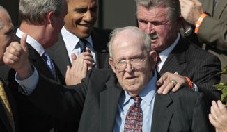 FILE - In this Oct. 7, 2011, file photo, former Bears&#x27; defensive coordinator Buddy Ryan gestures as he walks in with former head coach Mike Ditka, and President Barack Obama, during an event honoring the 1985 Super Bowl XX Champions Chicago Bears football team on the South Lawn of the White House in Washington. Buddy Ryan, who coached two defenses that won Super Bowl titles and whose twin sons Rex and Rob have been successful NFL coaches, died Tuesday, June 28, 2016. He was 82. (AP Photo/Pablo Martinez Monsivais, File)