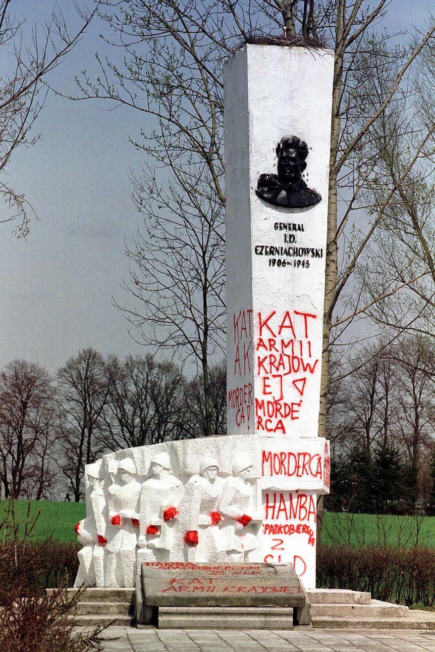 FILE - In this April 30, 2001 file photo taken in Pieniezno, Poland, graffiti with insults like "Murderer" and "Shame" can be seen on a memorial to Soviet General Ivan Chernyakhovsky, who is considered a symbol of the imposition of communism in Poland, but a national hero in Russia. Polish authorities are planning to move more than 200 communist-era monuments to Soviet troops into a former Red Army base to testify to a historic “untruth.” Pawel Ukielski, deputy head of the state Institute of National Remembrance, or IPN, said that the plan covers structures put up in the 1940s and ‘50s to glorify the Red Army’s march through Poland at the end of World War II as it was defeating the Nazi Germans.(AP Photo/Wojtek Jakubowski, File) POLAND OUT