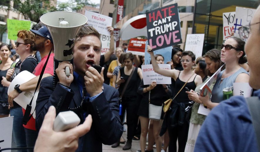 A rehearsal for Cleveland? Protestors chant outside a campaign event for Donald Trump in Boston on Wednesday. (AP Photo/Bill Sikes)