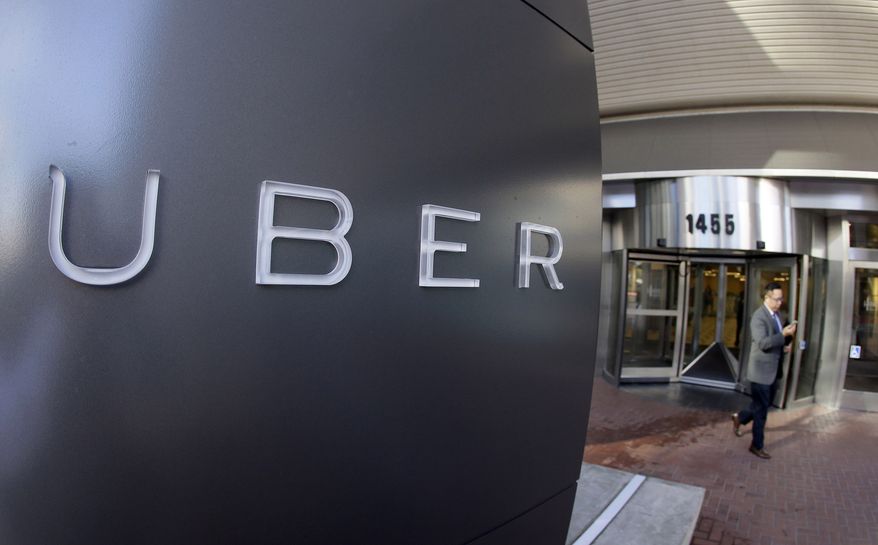 In this Dec. 16, 2014, file photo a man leaves the headquarters of Uber in San Francisco. (AP Photo/Eric Risberg, File)