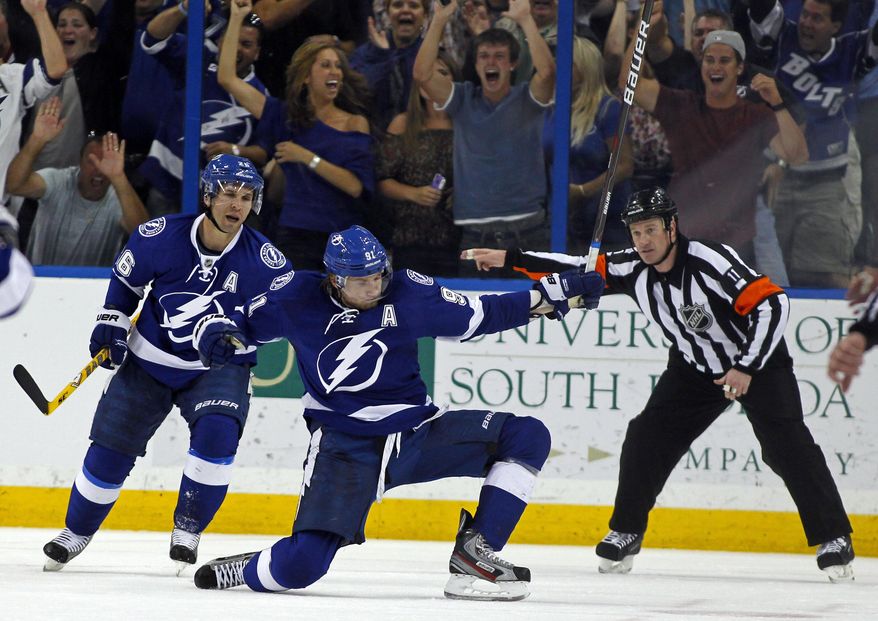 FILE - In this April 2, 2012, file photo, Tampa Bay Lightning's Steven Stamkos, center, celebrates with teammate Martin St. Louis as referee Kelly Sutherland signals Stamkos' goal during the third period of an NHL hockey game against the Washington Capitals, in Tampa, Fla. Steven Stamkos isn't the only "big fish" available when NHL free agency opens Friday at noon. The top-tier talent is deeper than in many recent years with Milan Lucic, Loui Eriksson, Brian Campbell and others available. (AP Photo/Mike Carlson, File)