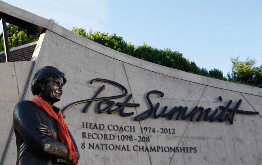 An orange scarf is placed around the statue of Pat Summitt before a candlelight vigil at the Pat Summitt Plaza, Wednesday, June 29, 2016, in Knoxville, Tenn. Summitt, the winningest coach in Division I college basketball history who uplifted the women's game from obscurity to national prominence during her career at Tennessee, died Tuesday. She was 64. (AP Photo/Wade Payne)