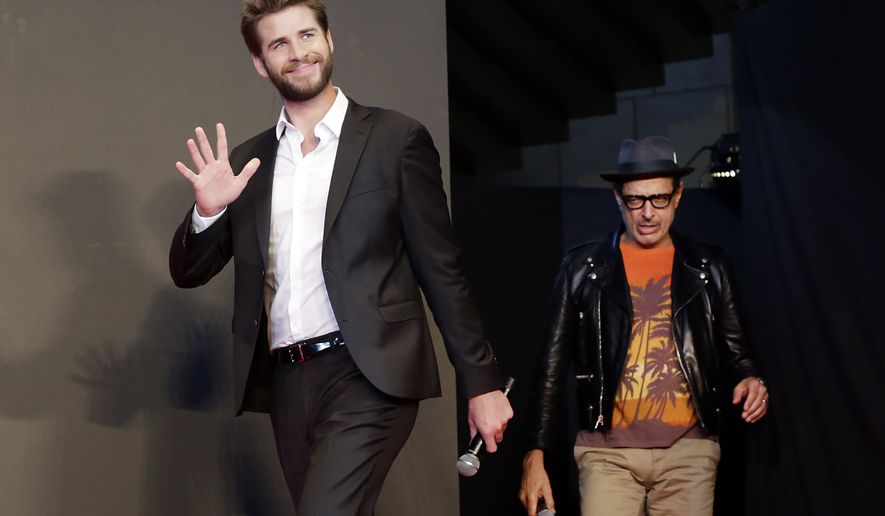 Actors Liam Hemsworth, left, and Jeff Goldblum walk in the stage during a promotional event for the movie "Independence Day: Resurgence" in Tokyo, Thursday, June 30, 2016. Mr. Hemsworth was named by PETA on July 7 as the sexiest male vegetarian celebrity of 2016 (AP Photo/Eugene Hoshiko)