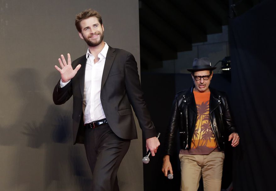 Actors Liam Hemsworth, left, and Jeff Goldblum walk in the stage during a promotional event for the movie "Independence Day: Resurgence" in Tokyo, Thursday, June 30, 2016. Mr. Hemsworth was named by PETA on July 7 as the sexiest male vegetarian celebrity of 2016 (AP Photo/Eugene Hoshiko)