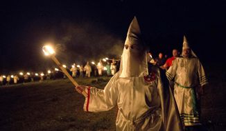 In this Saturday, April 23, 2016, photo, members of the Ku Klux Klan participate in cross burnings after a &amp;quot;white pride&amp;quot; rally in rural Paulding County near Cedar Town, Ga. (AP Photo/John Bazemore) ** FILE **