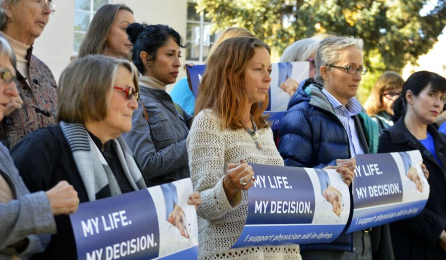 FILE-In this Oct. 26, 2015, file photo, right to die advocates rally outside the New Mexico Supreme Court in Santa Fe, N.M., after a lawyer asked justices to allow terminally-ill patients to end their lives. In a 5-0 opinion issued Thursday, June 30, 2016, the high court overturned a previous district court decision that doctors could not be prosecuted under the state&#39;s assisted suicide law, which classifies helping with suicide as a fourth-degree felony. (AP Photo/Russell Contreras, File)