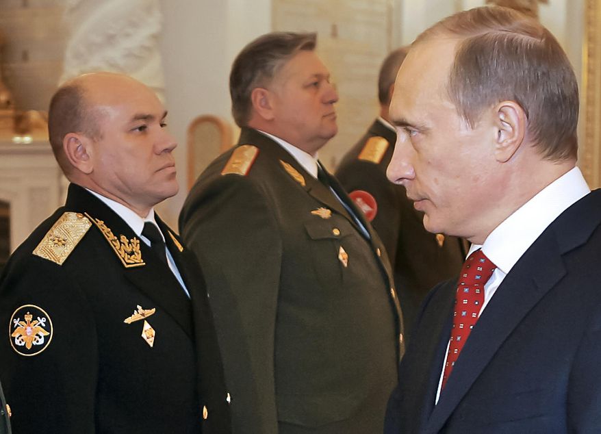 FILE In this file photo taken on Thursday, Feb. 30, 2016, Russian President Vladimir Putin, right, looks at Rear Adm. Viktor Kravchuk, left, during his meeting with a group of top military officers in the Moscow Kremlin, Russia. Russia's defense minister has fired the commander of the Baltic Fleet Viktor Kravchuk, and his top officers following a sweeping inspection. (Vladimir Rodinov, Sputnik, Kremlin Pool Photo via AP, file)