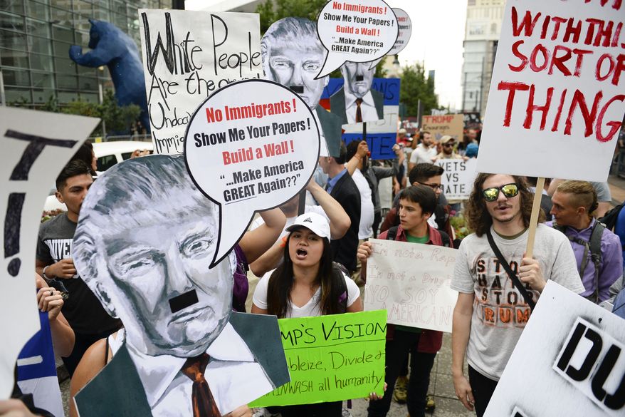 Donald Trump protesters chant outside the Western Conservative Summit on Friday, July 1, 2016, in Denver. (Michael Reaves/The Denver Post via AP) ** FILE **