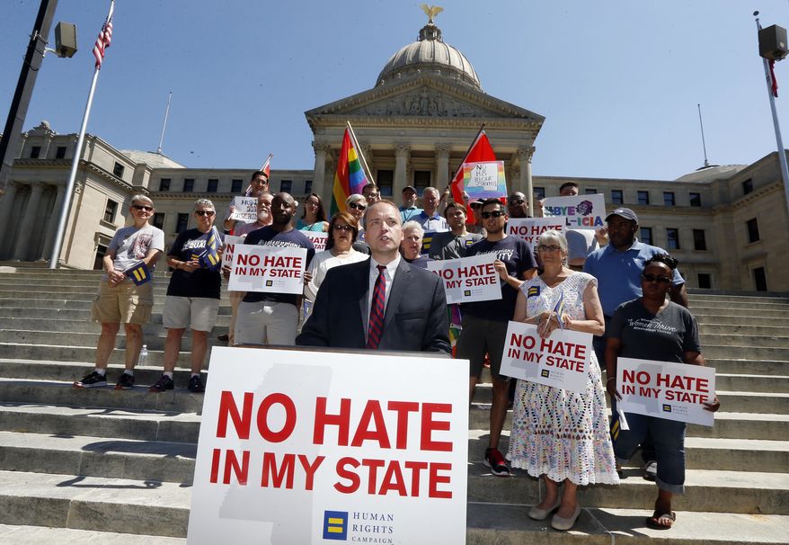 Rob Hill, state director of the Human Rights Campaign Mississippi, speaks on the steps of the Mississippi Capitol in Jackson, Miss., Friday, July 1 2016, as he and others celebrated Thursday's ruling of a federal judge who blocked a Mississippi law on religious objections to same-sex marriage moments before it was set to take effect Friday, ruling it unconstitutionally establishes preferred beliefs and creates unequal treatment for gay people. (AP Photo/Rogelio V. Solis)