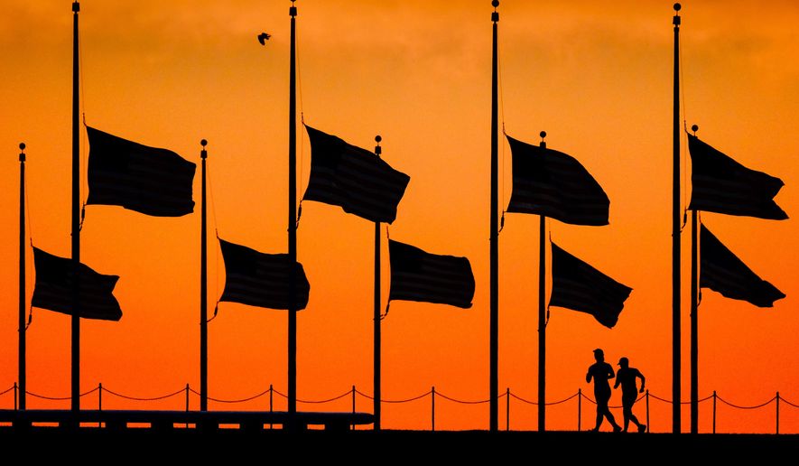 FILE - In this June 13, 2016 file photo, flags fly at half-staff around the Washington Monument at daybreak in Washington, by order of President Obama, the day after more than four dozen people were killed in the Orlando, Fla., nightclub shootings. As the nation marks Independence Day on Monday, lowering the flag remains a visible, immediate way to pay tribute in hours of tragedy, but flag buffs have noted that the honor has been extended more widely over time, and they and other Americans have questioned whether the country has lowered the bar on the lowering the flag. (AP Photo/J. David Ake, File)