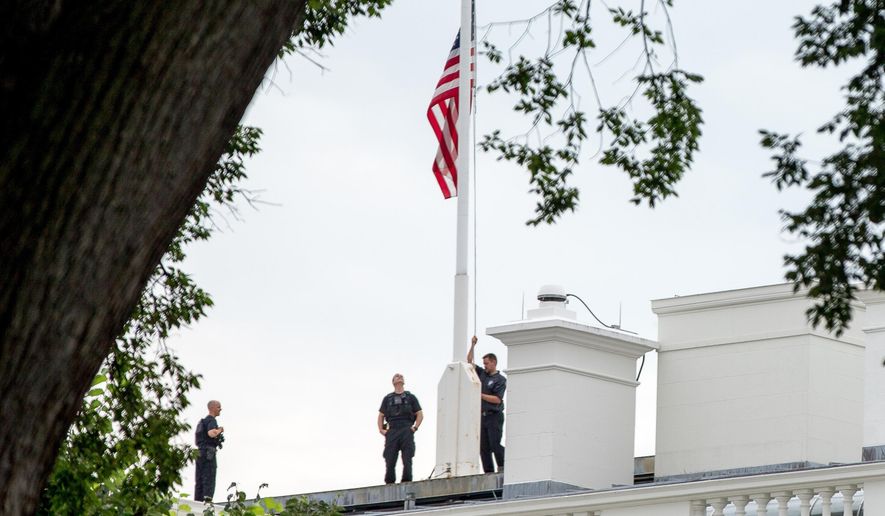 FILE- In this July 21, 2015 file photo, the American flag is lowered to half-staff above the White House in Washington to honor the five U.S. service members who were killed by a gunman in Chattanooga, Tenn. the week before. Nearly every day somewhere in the country, the Stars and Stripes is flying low, ordered to half-staff in one of the most significant gestures of mourning and respect. An Associated Press analysis of proclamations from 50 state governors and the federal government found flags were ordered lowered at least someplace 325 days out of 2015. (AP Photo/Andrew Harnik, File)