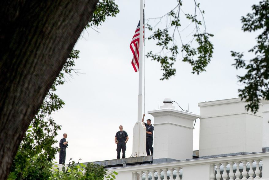 FILE- In this July 21, 2015 file photo, the American flag is lowered to half-staff above the White House in Washington to honor the five U.S. service members who were killed by a gunman in Chattanooga, Tenn. the week before. Nearly every day somewhere in the country, the Stars and Stripes is flying low, ordered to half-staff in one of the most significant gestures of mourning and respect. An Associated Press analysis of proclamations from 50 state governors and the federal government found flags were ordered lowered at least someplace 325 days out of 2015. (AP Photo/Andrew Harnik, File)