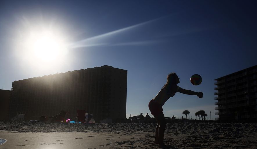 In this, Friday, July 1, 2016, Bevin Walker, 12, of Sylacauga, Ala., plays volleyball near the shoreline with her family in Orange Beach, Ala. (AP Photo/Brynn Anderson) **FILE**