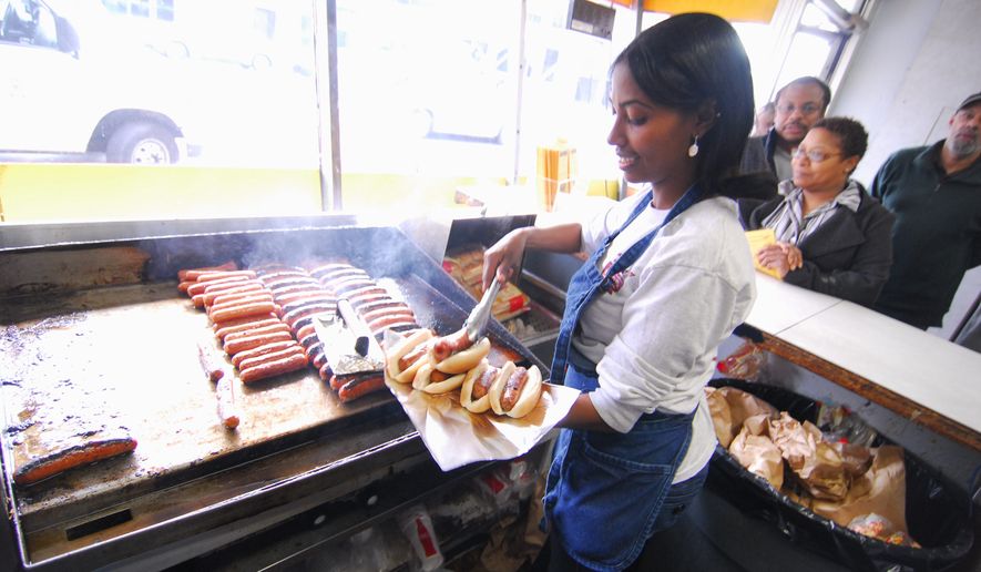The kitchen at Ben&#x27;s Chili Bowl churns out its take on the iconic capital food known as a half-smoke, often smothered in chili. (The Washington Times)