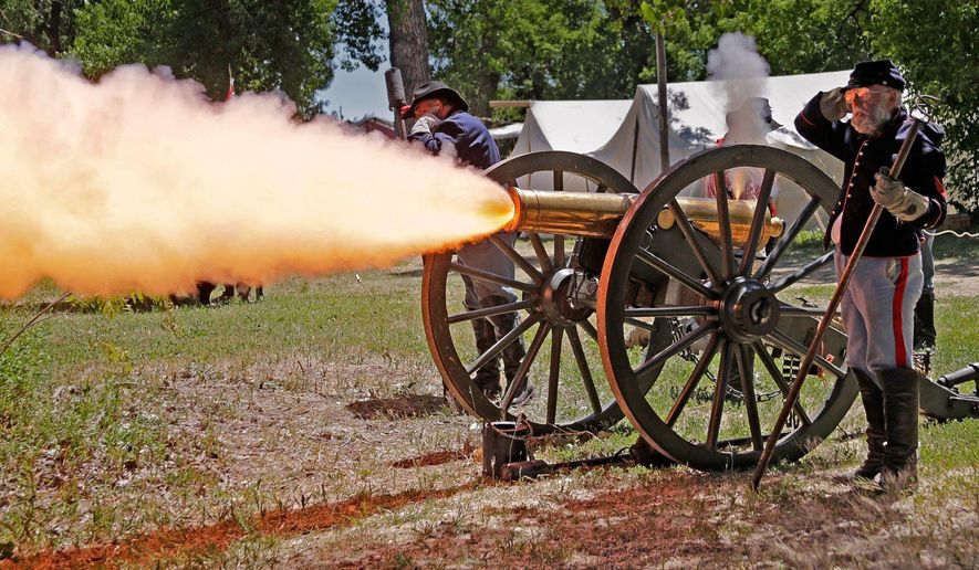 In this June 22, 2016 photo, a historic 12-pound howitzer from Fort Phil Kearny in Wyoming is fired at the U.S. Cavalry School, in Crow Agency, Mont. (Bob Zellar /The Billings Gazette via AP)