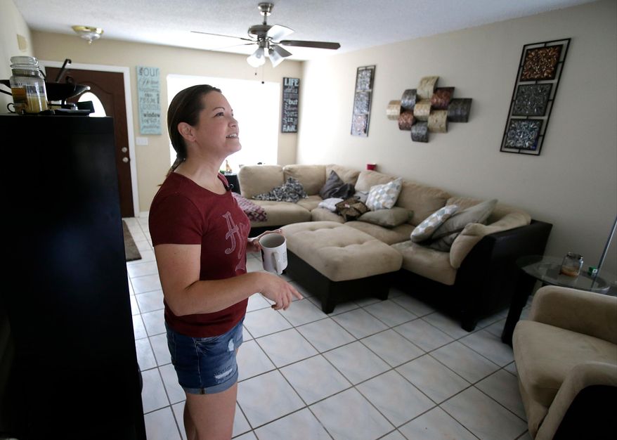 FILE - In this Thursday, April 14, 2016, file photo, renter Nicole Caverly gets settled at her home in the Piedmont Park neighborhood in Apopka, Fla., a former agricultural hub now crowded with housing developments. Where one in 10 homes was once a rental, now more than a third are. Caverly began renting in the Piedmont Park neighborhood this year. The previous owners had lost the three-bedroom house to foreclosure in 2015, after which it was bought by Freo Florida LLC in January. (AP Photo/John Raoux, File)