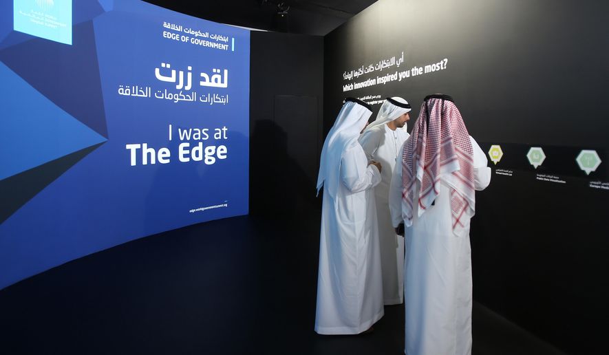 FILE -- In this Feb. 8, 2016 file photo, Emirati officials visit an exhibition at the World Government Summit in Dubai, United Arab Emirates. In a tweet late Saturday, July 2, 2016 from the Ministry of Foreign Affairs warned its citizens to avoid wearing traditional garments when traveling abroad after an Emirati man was handcuffed last week in Ohio over terrorism fears. Local media reported Sunday that Emirati national Ahmed al-Menhali was detained at gunpoint last week while wearing a traditional white kandura, or ankle-length robe, and headscarf in Avon, Ohio after a hotel clerk raised suspicions he could have links to the Islamic State group. (AP Photo/Kamran Jebreili)