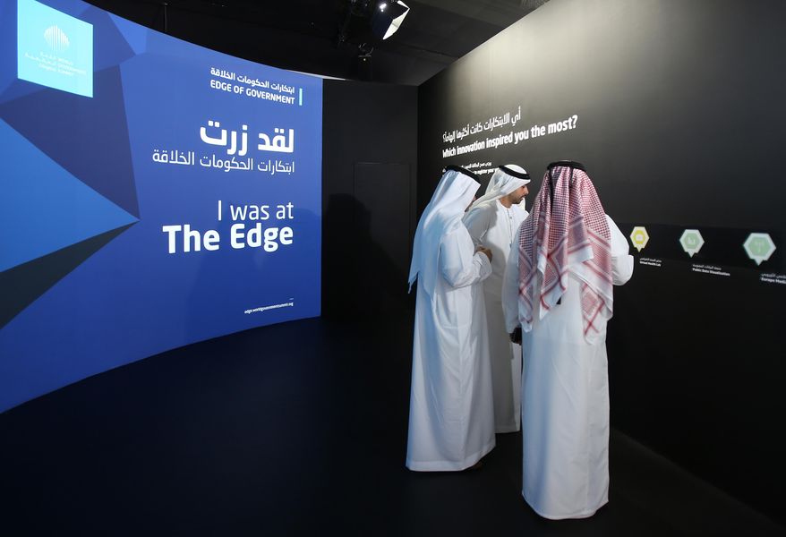 FILE -- In this Feb. 8, 2016 file photo, Emirati officials visit an exhibition at the World Government Summit in Dubai, United Arab Emirates. In a tweet late Saturday, July 2, 2016 from the Ministry of Foreign Affairs warned its citizens to avoid wearing traditional garments when traveling abroad after an Emirati man was handcuffed last week in Ohio over terrorism fears. Local media reported Sunday that Emirati national Ahmed al-Menhali was detained at gunpoint last week while wearing a traditional white kandura, or ankle-length robe, and headscarf in Avon, Ohio after a hotel clerk raised suspicions he could have links to the Islamic State group. (AP Photo/Kamran Jebreili)