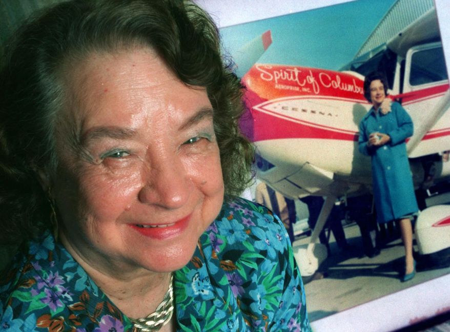 FILE - In this March 25, 1994, file photo, Geraldine &amp;quot;Jerrie&amp;quot; Mock poses, in Quincy, Fla., next to a photograph of her that was taken minutes before her historic around-the-world flight in 1964. An exhibit memorializing Jerrie Mock opened recently at The Works: Ohio Center for History, Art and Technology in Newark, Ohio, her hometown.  (Mike Ewen/Tallahasee Democrat via AP, File)