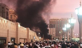 In this photo provided by Noor Punasiya, people stand by an explosion site in Medina, Saudi Arabia, Monday, July 4, 2016. State-linked Saudi news websites reported an explosion Monday near one of Islam&#39;s holiest sites in the city of Medina, as two suicide bombers struck in different cities. (Courtesy of Noor Punasiya via AP)