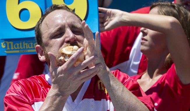 Joey Chestnut competes in Nathan&#x27;s Famous Fourth of July International Hot Dog Eating Contest men&#x27;s competition, Monday, July 4, 2016, in New York. Chestnut came in first eating 70 hot dogs and buns in 10 minutes. (AP Photo/Mary Altaffer)
