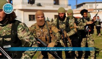 This file photo posted on the Twitter page of Syria&#39;s al-Qaida-linked Nusra Front on April 1, 2016, shows fighters from al-Qaida&#39;s branch in Syria, the Nusra Front, marching toward the northern village of al-Ais in Aleppo province, Syria. (Al-Nusra Front via AP, File)